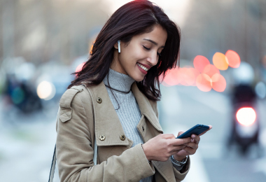 woman with cell phone and airpods