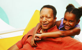 young black girl hugs her grandfather